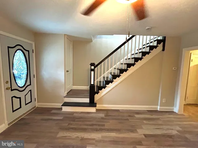 a view of entryway and hall with wooden floor