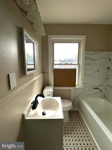 a bathroom with a sink a mirror and a bathtub