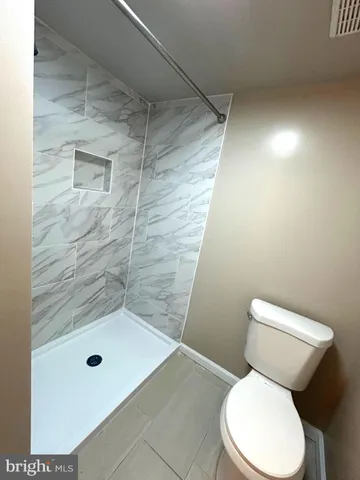 a bathroom with a toilet and shower