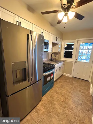 a kitchen with stainless steel appliances a refrigerator and a microwave