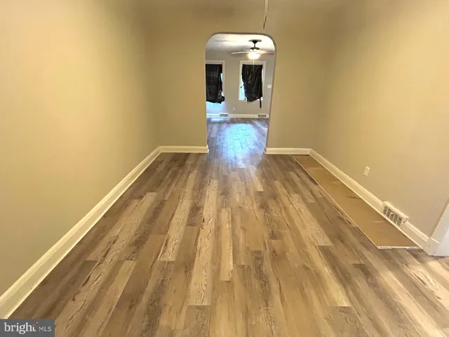 a view of a room with wooden floor