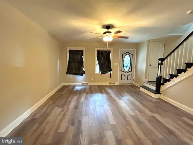 wooden floor in an empty room with a window
