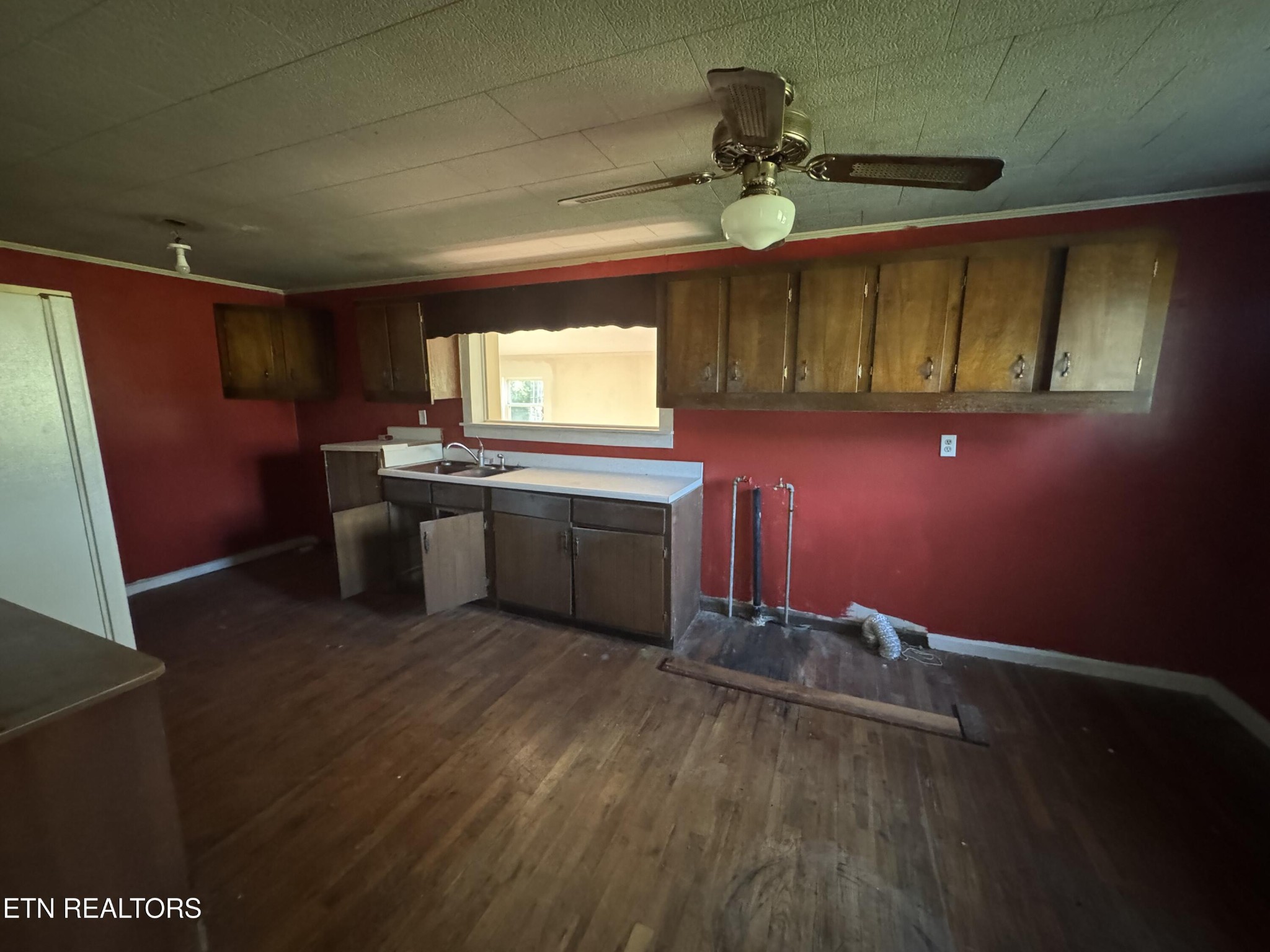 156 Sam Davis Road Decatur, TN 37322 - Photo 3 of 11 a kitchen with stainless steel appliances granite countertop a sink cabinets and wooden floor