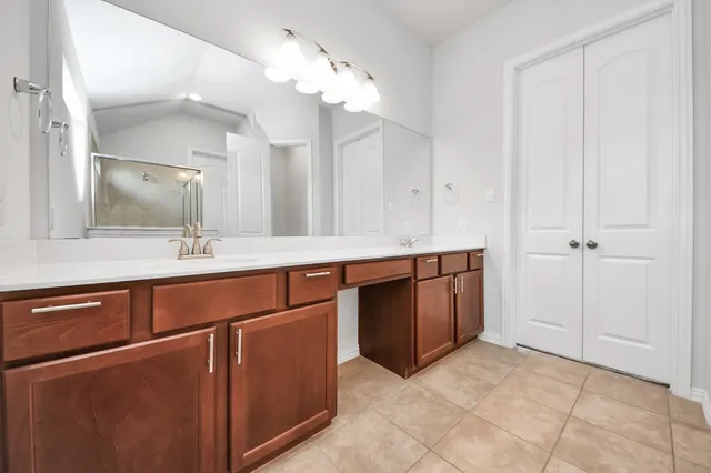 a spacious bathroom with a sink and a mirror