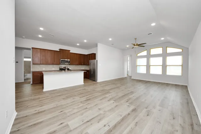 a view of a kitchen with a sink and a window