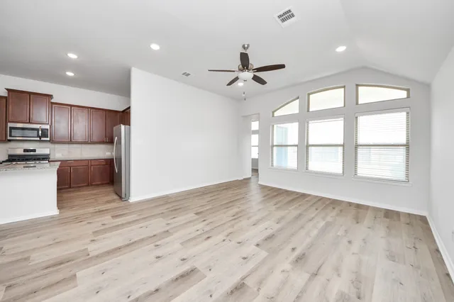 a view of a kitchen with a sink and a window