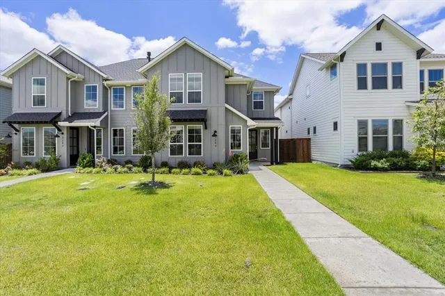 a front view of a house with yard and green space