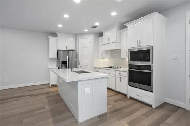 a kitchen with a stove a sink and a refrigerator