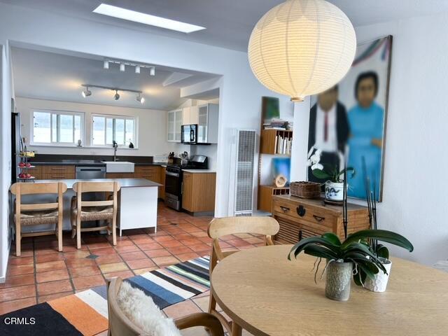 213 Rossmore Drive Oxnard, CA 93035 - Photo 11 of 28 an open kitchen with dining table and stainless steel appliances