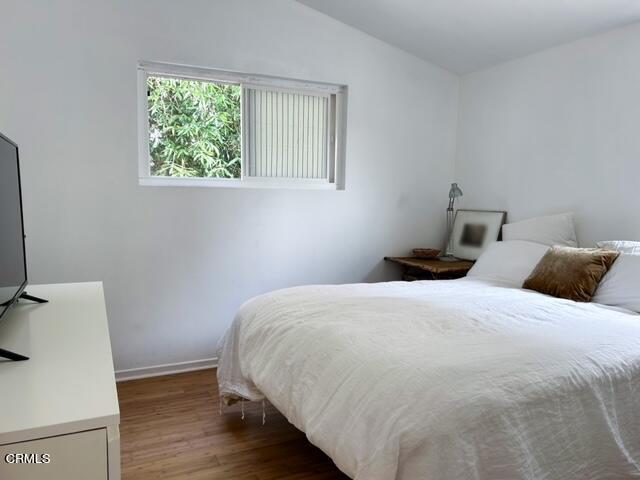 213 Rossmore Drive Oxnard, CA 93035 - Photo 25 of 28 a bedroom with a bed and wooden floor