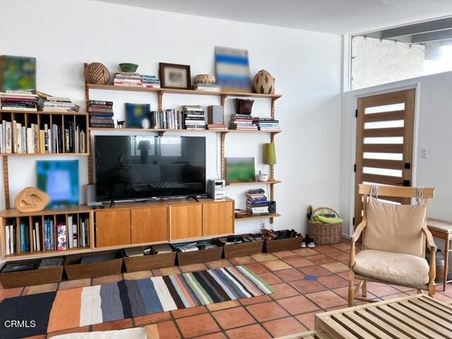 213 Rossmore Drive Oxnard, CA 93035 - Photo 8 of 28 a living room with furniture a flat screen tv and a book shelf