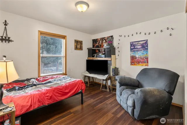 a bedroom with a bed and a chair