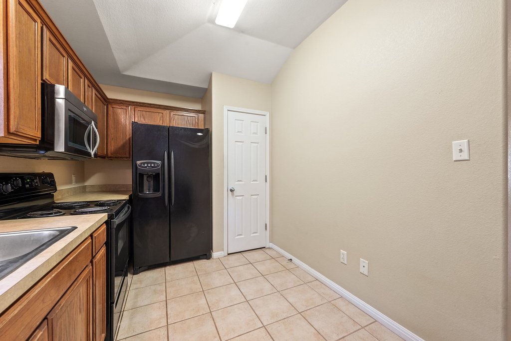 5208 Sioux Lane Austin, TX 78734 - Photo 9 of 35 Functional kitchen with ample cabinetry and essential appliances awaits your personal touch.