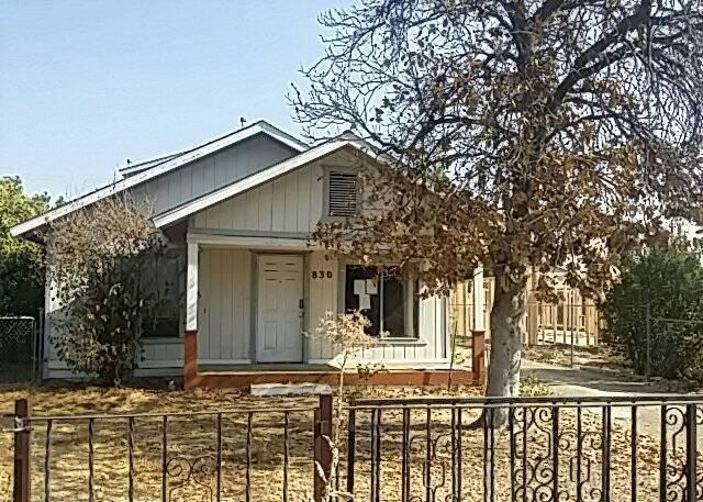 830 East Duff Avenue Reedley, CA 93654 - Photo 1 of 7 a front view of a house with trees