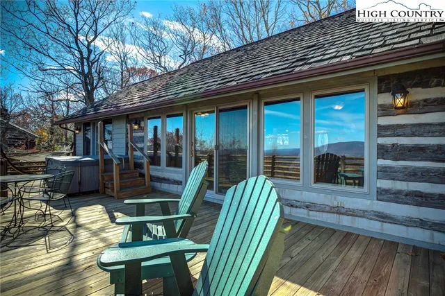 a view of a patio with table and chairs with wooden fence and plants