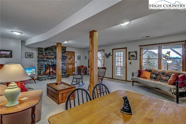 a living room with furniture a rug and a large window