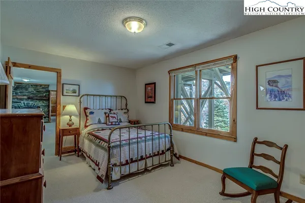 a bedroom with a bed chair and window