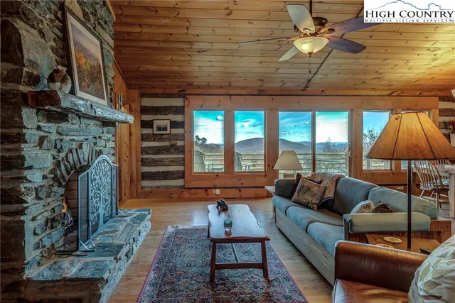 a kitchen with stainless steel appliances granite countertop a table chairs and wooden floor