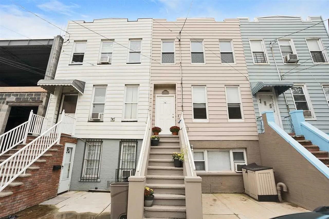 a view of white building with a sink and balcony