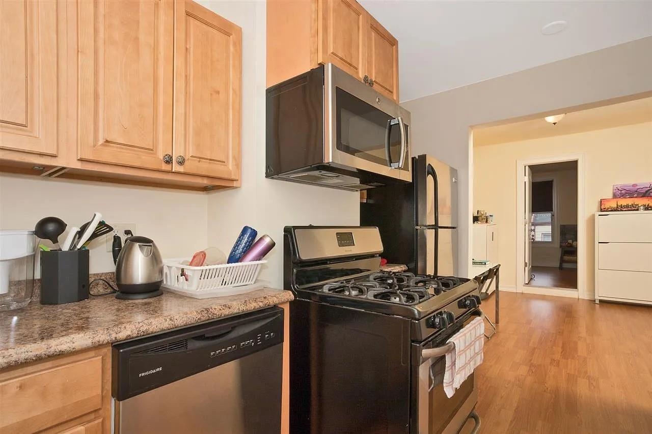363 5th Street, Unit 2 Jersey City, NJ 07302 - Photo 4 of 7 a kitchen with granite countertop stainless steel appliances and a sink