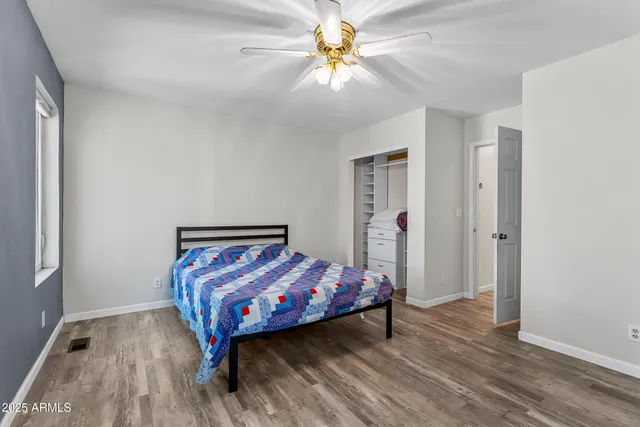 a bedroom with a bed and a chandelier