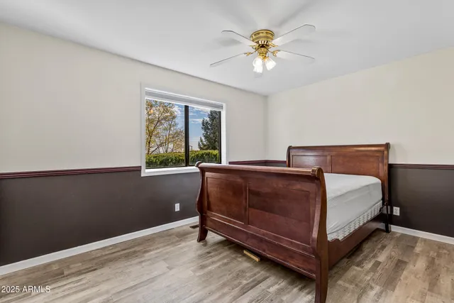 a bathroom with a granite countertop sink a toilet a mirror and shower