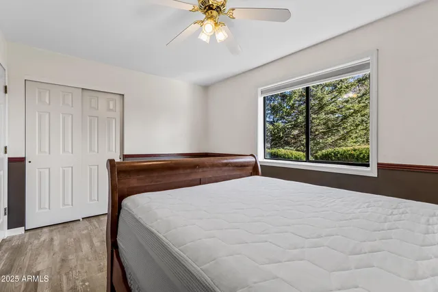 a bed sitting in a bedroom next to a window