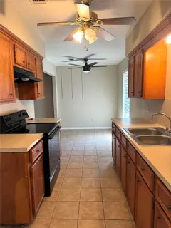 a kitchen with stainless steel appliances granite countertop a sink and a stove