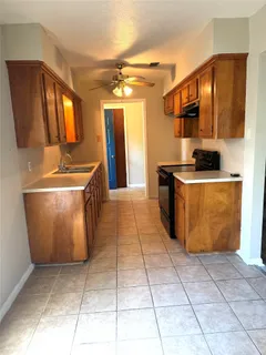 a kitchen with stainless steel appliances granite countertop a sink and a stove top oven