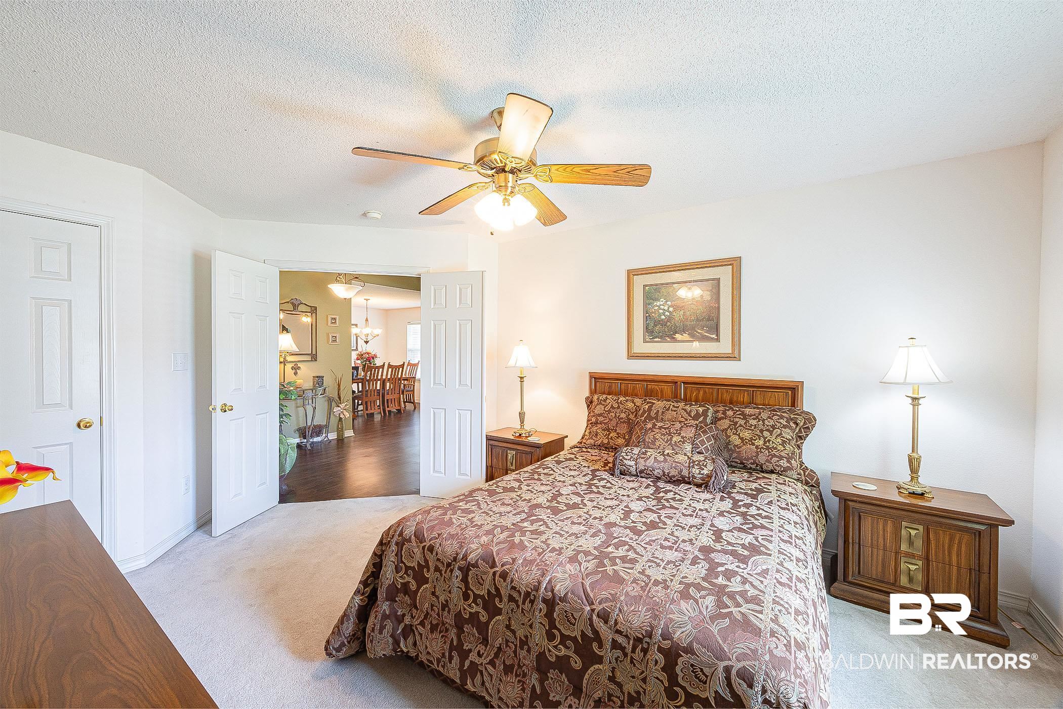 16154 Parke Boulevard Foley, AL 36535 - Photo 32 of 44 Bedroom with a textured ceiling, light colored carpet, and ceiling fan