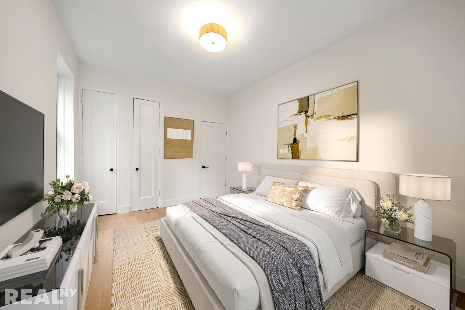 668 Riverside Drive, Unit 4G Manhattan, NY 11360 - Photo 3 of 11 a bedroom with a bed and a flat screen tv