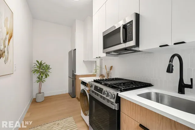 a kitchen with stainless steel appliances granite countertop a stove and a refrigerator