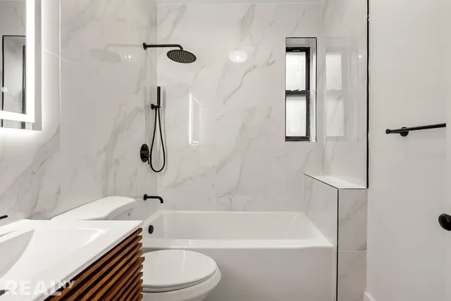 a kitchen with granite countertop a sink and a stove top oven