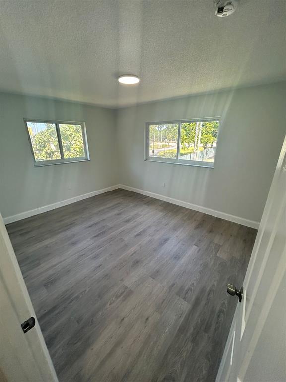 6601 Southwest 46th Street, Unit 203 Davie, FL 33314 - Photo 11 of 14 wooden floor in an empty room with a window