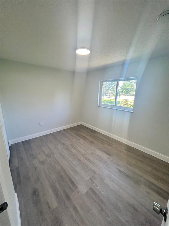 6601 Southwest 46th Street, Unit 203 Davie, FL 33314 - Photo 12 of 14 an empty room with wooden floor and windows