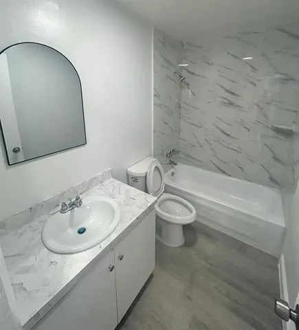 a bathroom with a sink toilet and shower