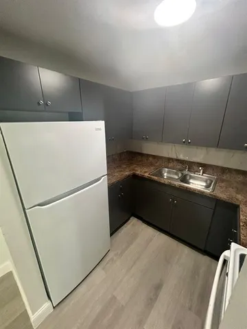a kitchen with a refrigerator and a stove