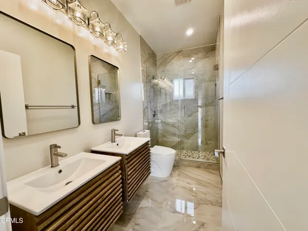 a bathroom with a sink double vanity and a mirror