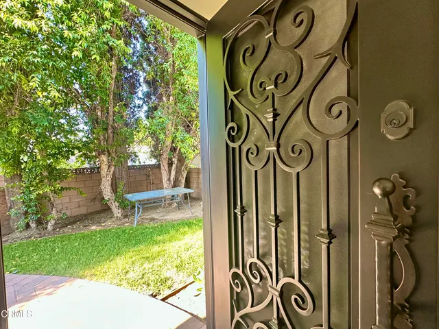 a view of a room with a bench and lawn chairs