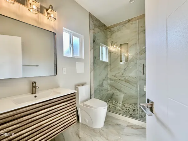 a bathroom with a sink toilet and shower