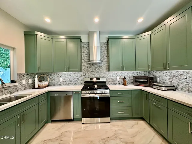 a kitchen with a sink stove and cabinets