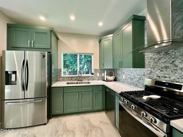 a kitchen with a stove sink and refrigerator