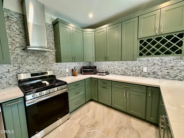 a kitchen with a sink stove and cabinets