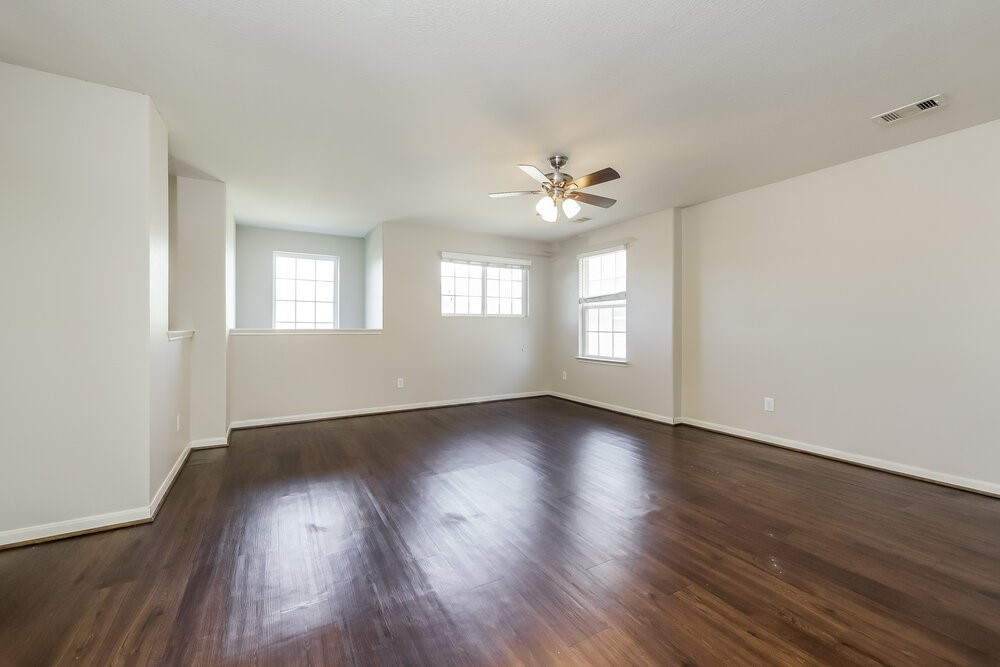 2818 Mesquite Ridge Drive Houston, TX 77073 - Photo 16 of 17 a view of an empty room with wooden floor and a window
