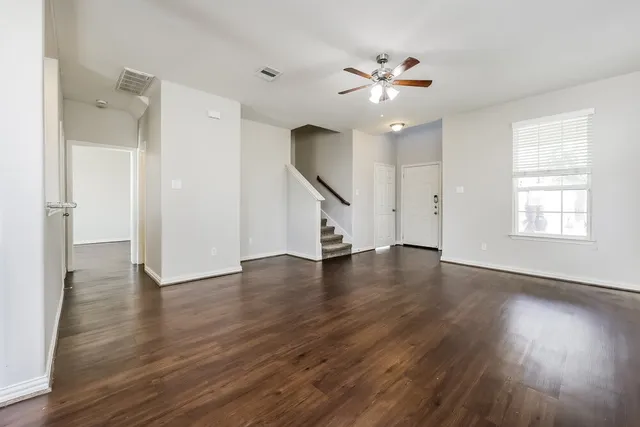 a view of a kitchen with wooden floor and a window