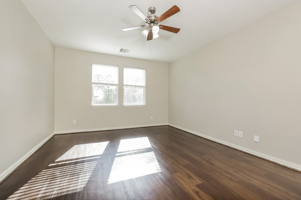 2818 Mesquite Ridge Drive Houston, TX 77073 - Photo 10 of 17 wooden floor in an empty room with a window