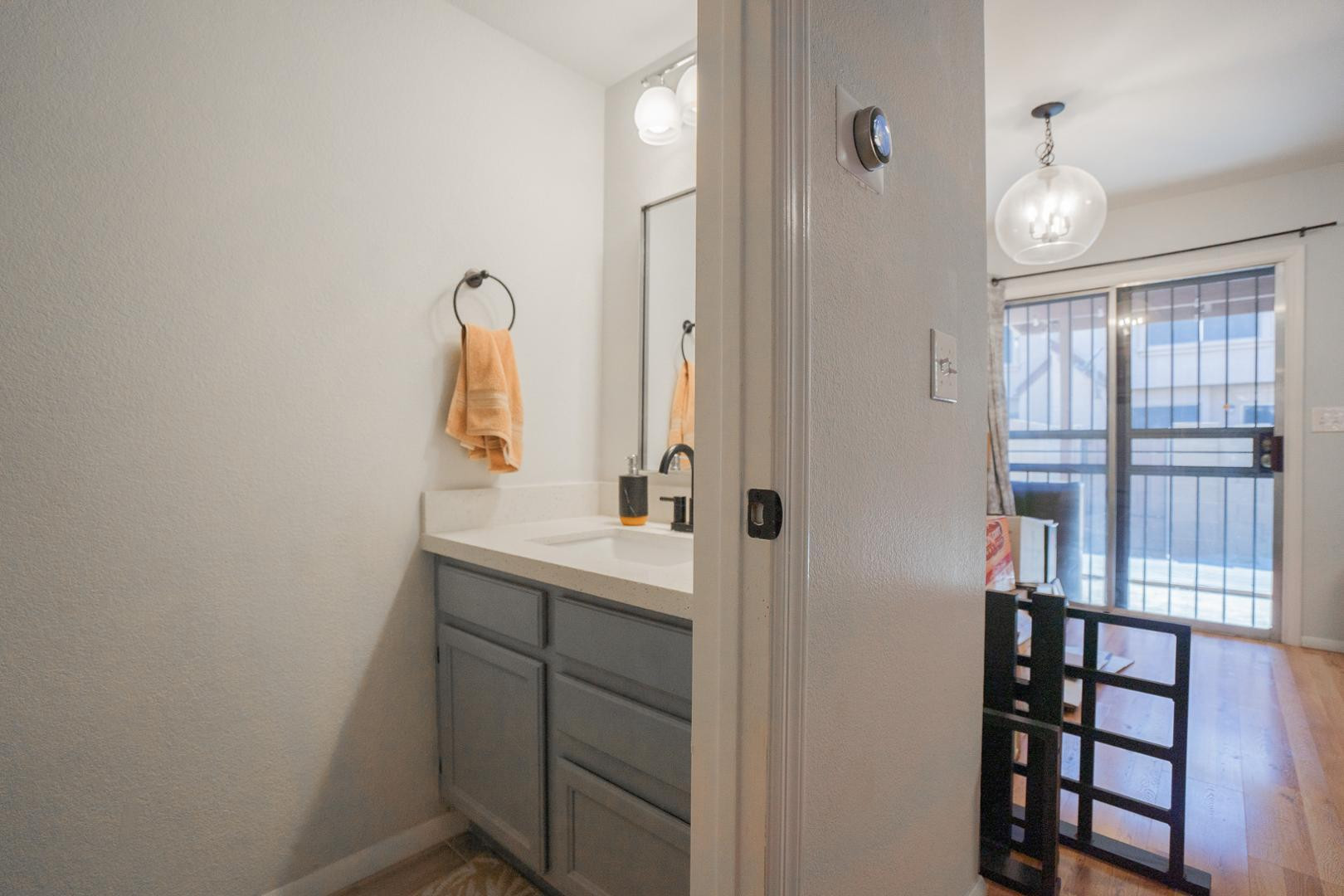 8111 West Wacker Road, Unit 70 Peoria, AZ 85381 - Photo 11 of 38 a bathroom with a sink a light fixture and a mirror