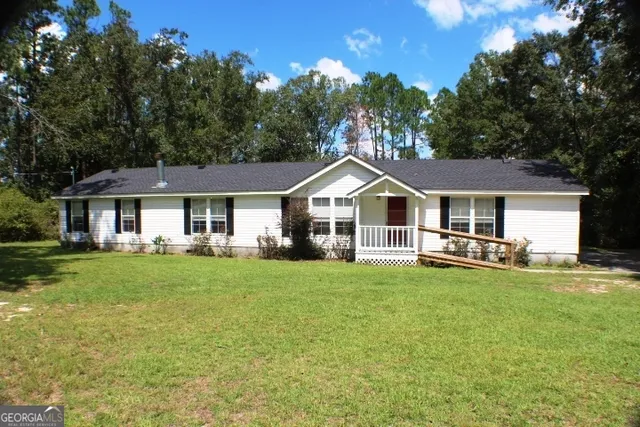 a front view of a house with a garden and porch