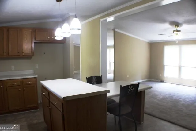 a kitchen with a table chairs and microwave