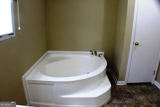 a white bath tub sitting in a bathroom